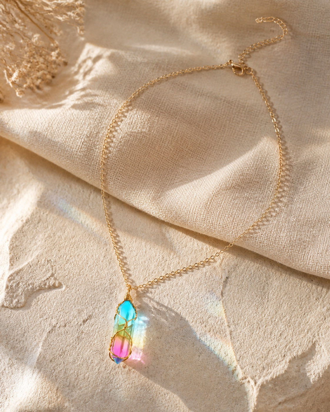Aurora amulet necklace styled on linen